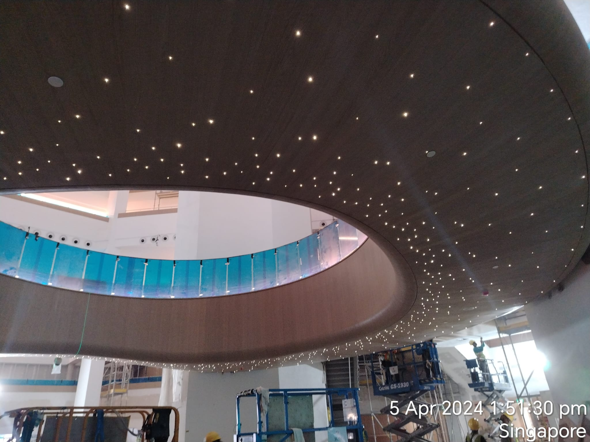 A court interior in Singapore with a curved ceiling and integrated points of light.